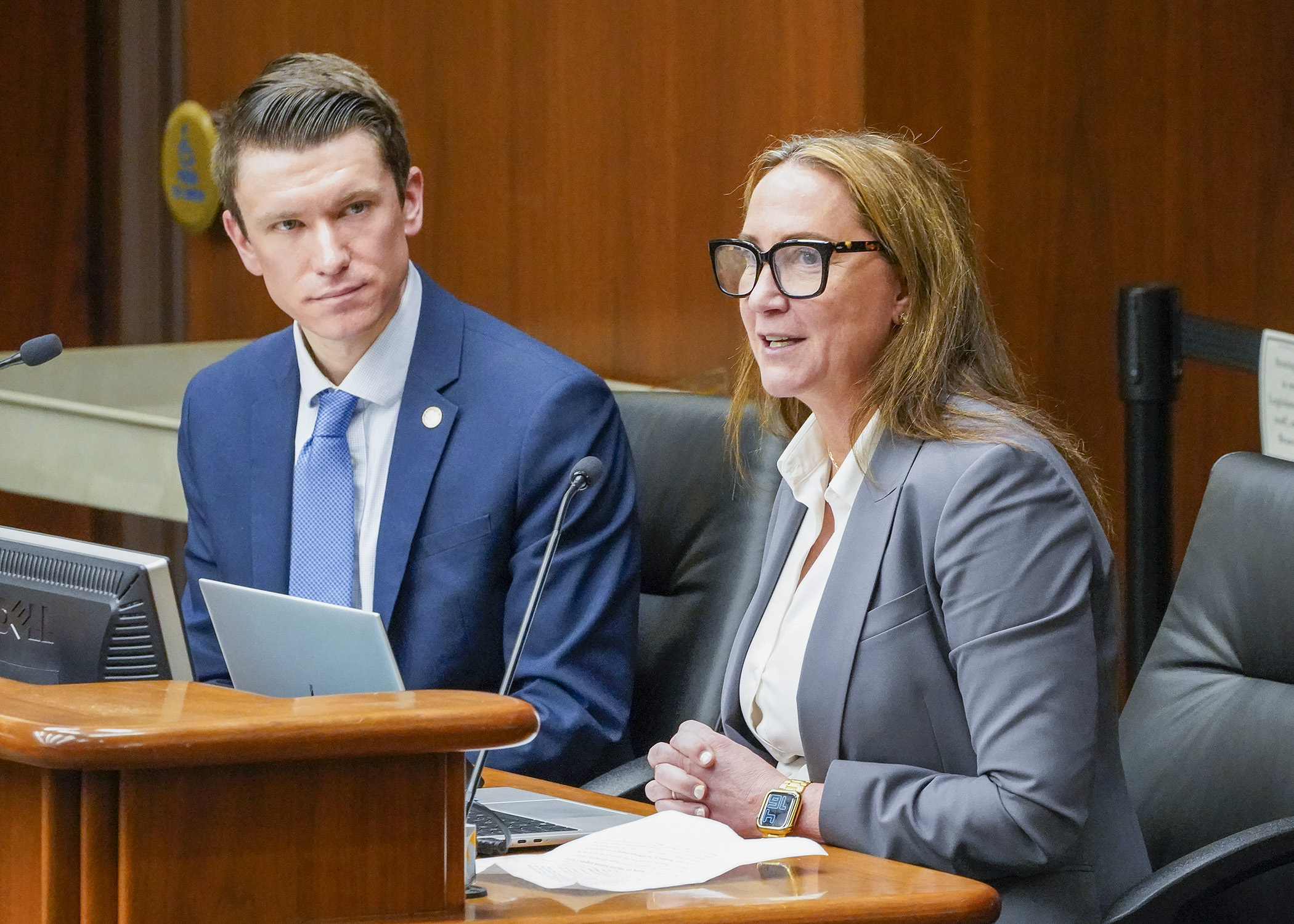 Cherie Shoquist-Henderson, Golden Valley’s housing and economic development manager, testifies March 7 for a bill sponsored by Rep. Matt Norris, left, that would create various grant programs to fund municipal housing projects. (Photo by Andrew VonBank)